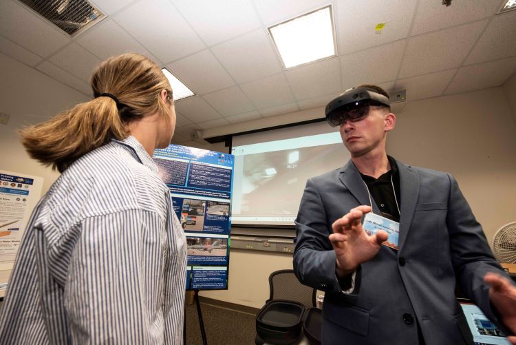 Capt Michael Ashmore, USMC, MOVES '23, demonstrates his thesis work at the 2023 MOVES Open House.